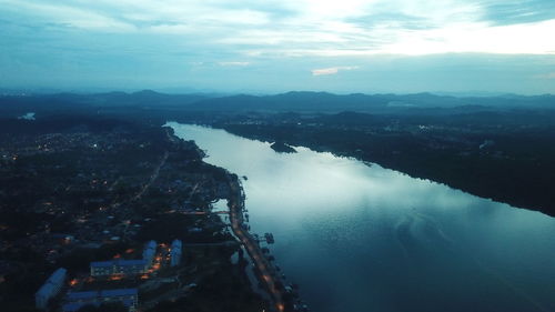 High angle view of city by sea against sky