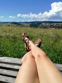 Low section of woman relaxing on field