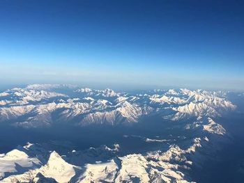 Scenic view of snow covered mountains against sky