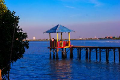 A hut by sea against sky