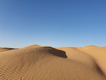 Scenic view of desert against clear sky