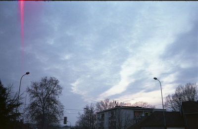 Low angle view of buildings against cloudy sky