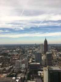 View of cityscape against cloudy sky