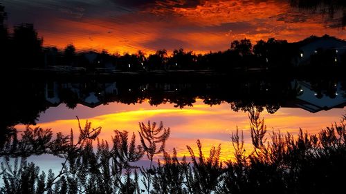Scenic view of lake against orange sky