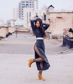 Full length of woman standing at terrace