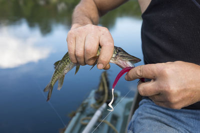 Close-up of man holding fish