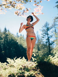 Low angle view of woman standing on hill