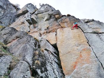 Low angle view of person on rock