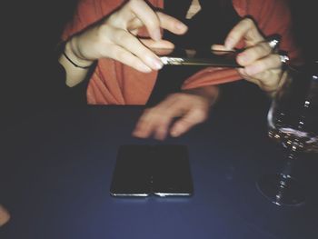 Cropped image of woman holding cigarette