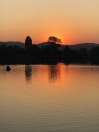 Scenic view of lake against romantic sky at sunset