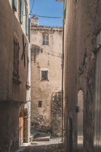 View in an old alley with sun at the end