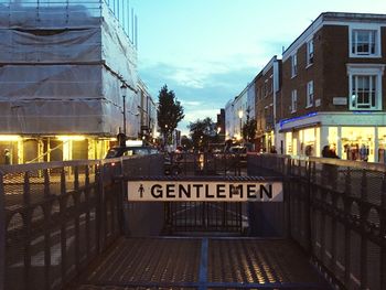 Information sign in city against sky