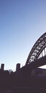 Low angle view of bridge against blue sky