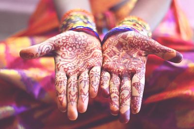 Midsection of woman showing henna tattoo