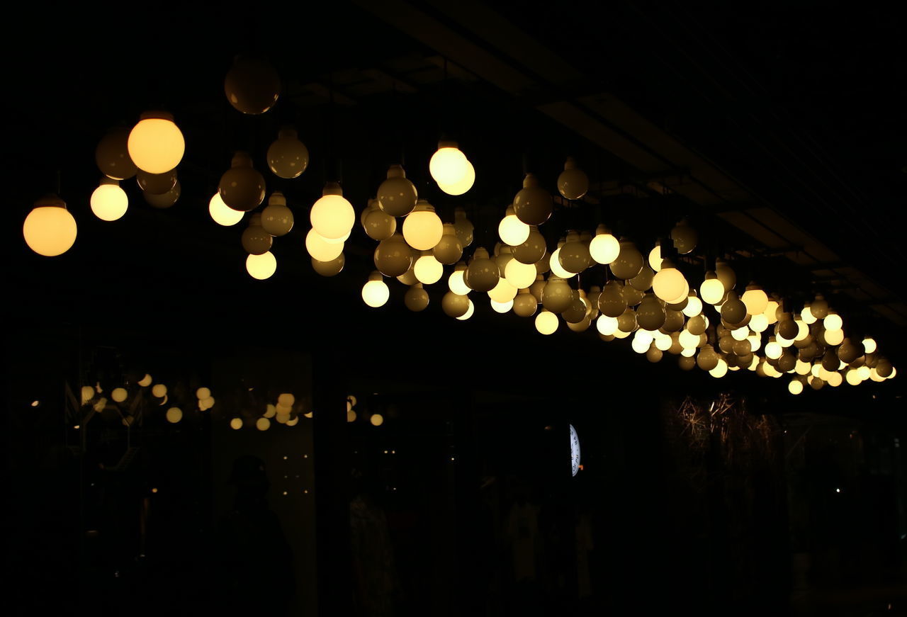 LOW ANGLE VIEW OF ILLUMINATED LIGHTS ON CEILING