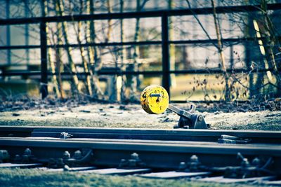 Close-up of yellow ball on railroad track