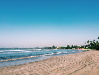 Scenic view of beach against blue sky