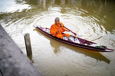 High angle view of man sitting in river