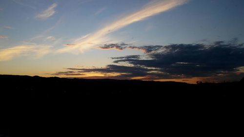 Silhouette of landscape against sunset sky