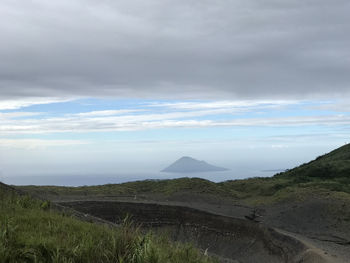 Scenic view of landscape against cloudy sky