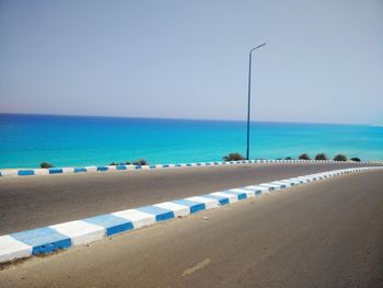 Scenic view of beach against clear blue sky