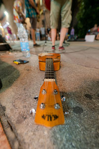 Low section of man playing guitar on street