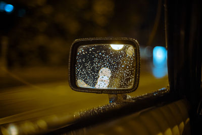 Close-up of raindrops on car windshield