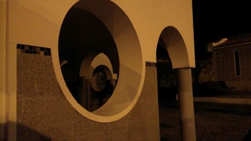 Information sign on wall of building at night