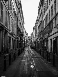 Empty alley amidst buildings in city