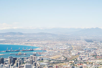 High angle view of cityscape by sea against sky