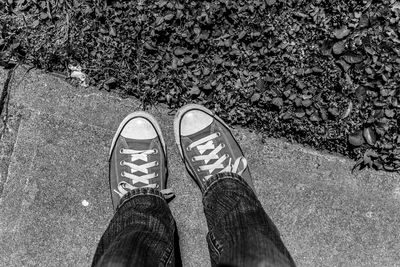 Low section of man standing on tiled floor