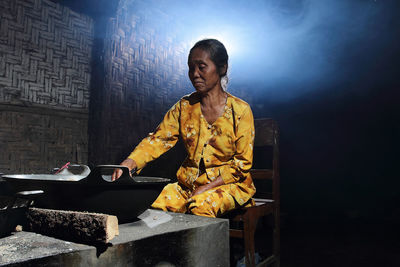 Woman preparing food in darkroom