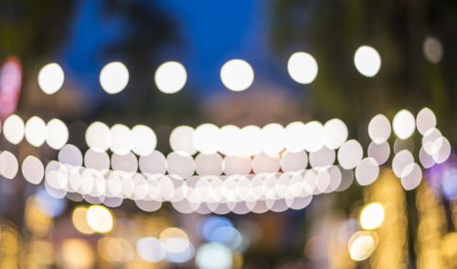 Defocused image of illuminated christmas lights at night