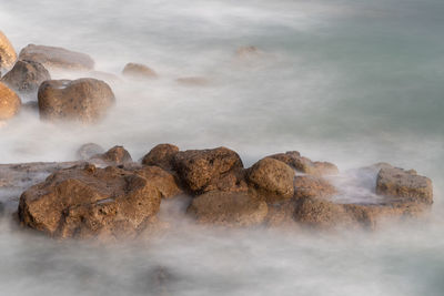 Long exposure of sea washing over rocks at the beach