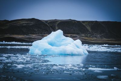 Frozen lake against sky during winter