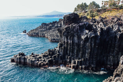 High angle view of rock formations by sea at jeju island