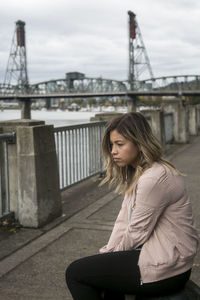 Woman looking at suspension bridge