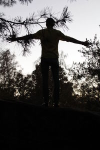 Full length of woman standing on tree trunk