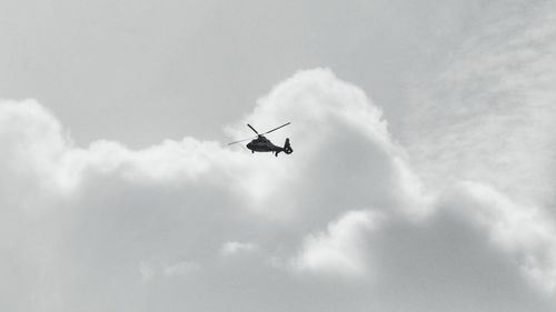 Low angle view of airplane flying in sky