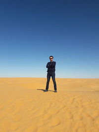 Full length of man standing on sand