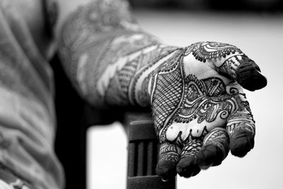 Woman showing her hand designed with henna tattoo