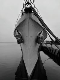 Ship moored at sea against sky