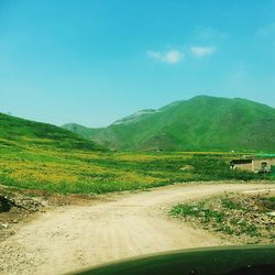 Dirt road passing through landscape