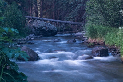 Scenic view of river flowing through rocks