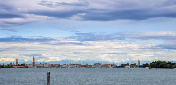 Panoramic view of seascape against skyline of buildings