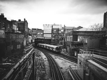 High angle view of railroad tracks amidst buildings in city