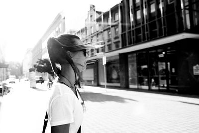 Rear view of woman standing on street