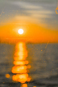 Close-up of yellow water splashing on street during sunset