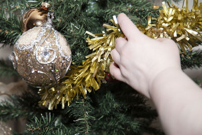 Close-up of hand holding tinsel