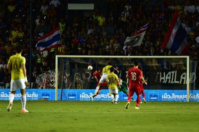 Group of people playing soccer on field